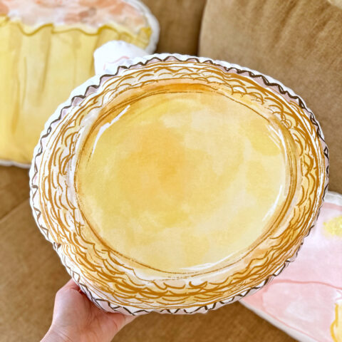 Alice holding an Egg Tart cushion